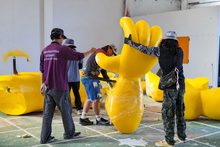 ESK crew shaping a large sculpted hand in the workshop